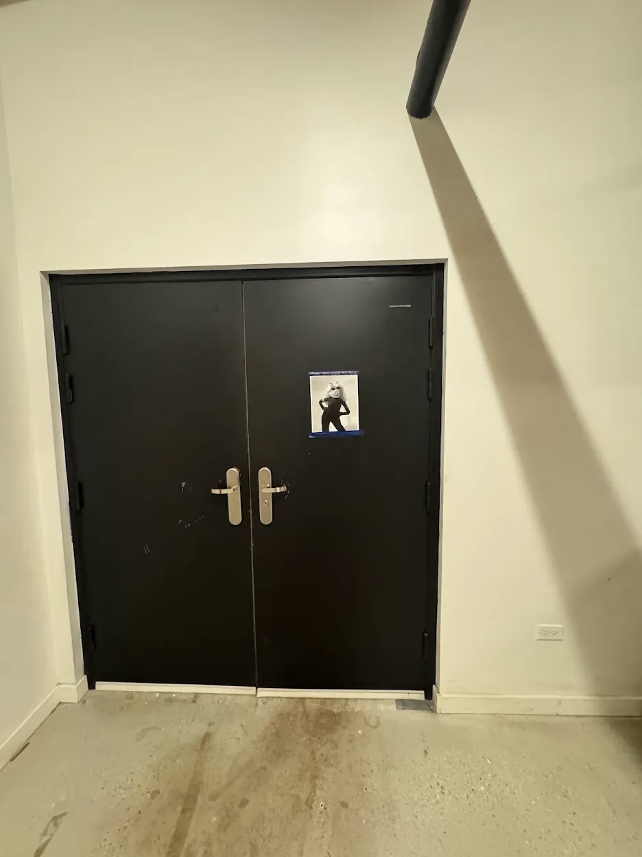 double black industrial doors with a single black and white printout taped to it