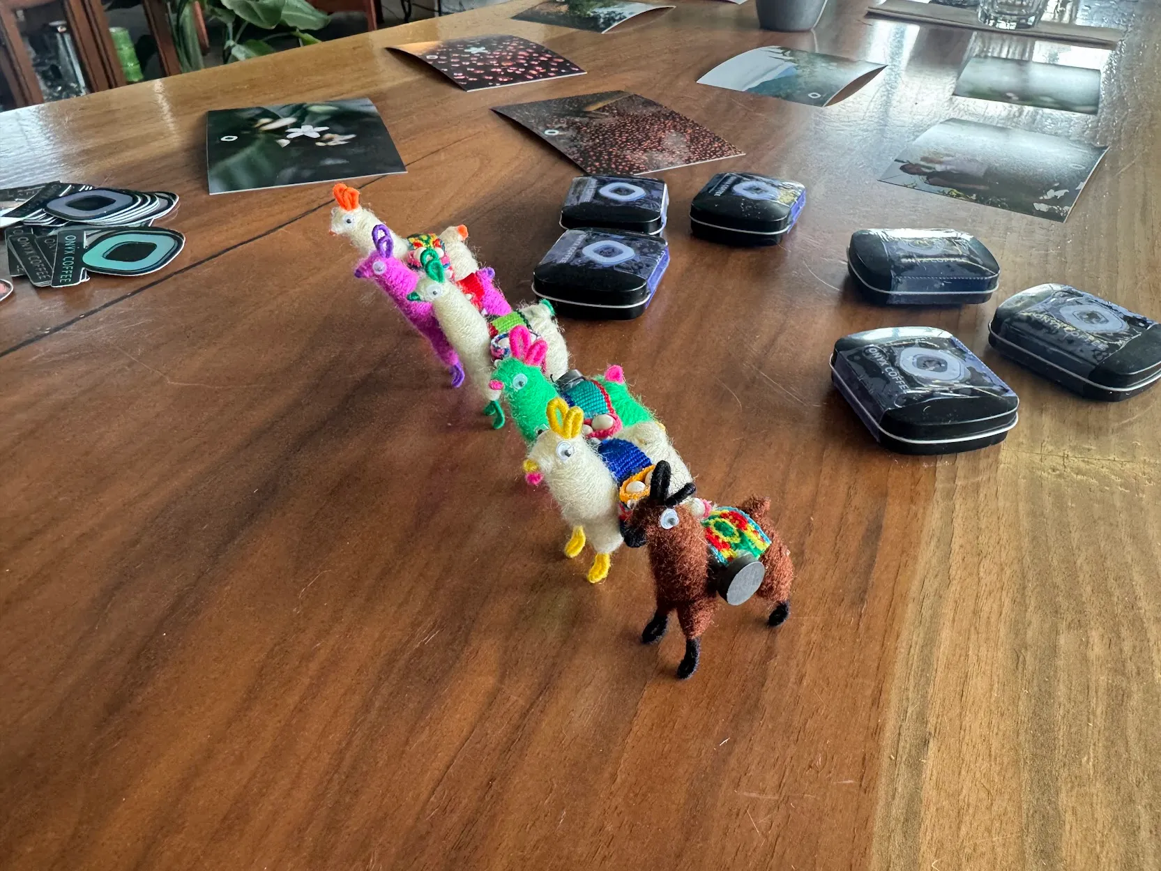 Alpacas, stickers, tasting spoons, and branded mints on a long table (angle shot)